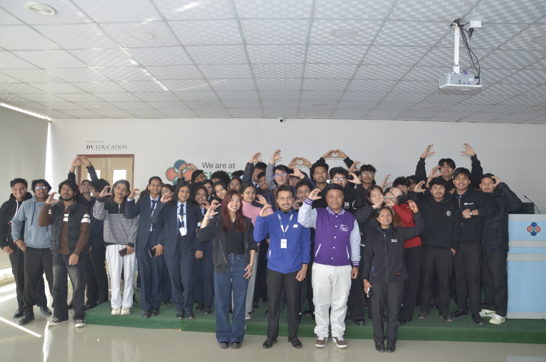 Attendees posing for a group photo at Explore the Cloud with AWS